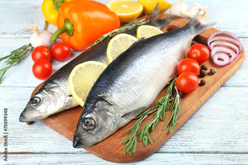 Fresh raw fish and food ingredients on table Fresh raw fish and food ingredients on table