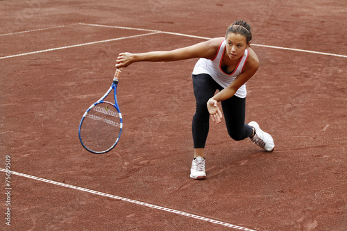 Young woman playing tennis © michael715