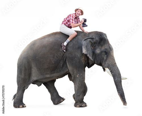 Photography cheerful tourist rides on an elephant carrying a camera