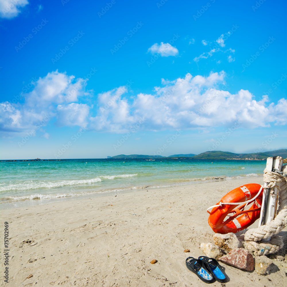 slippers and life buoy by the shore in Alghero slippers and life buoy by the shore in Alghero