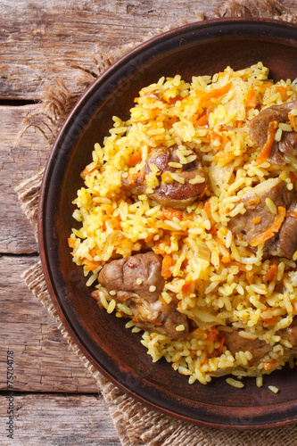 Rice with meat and vegetables closeup. vertical top view