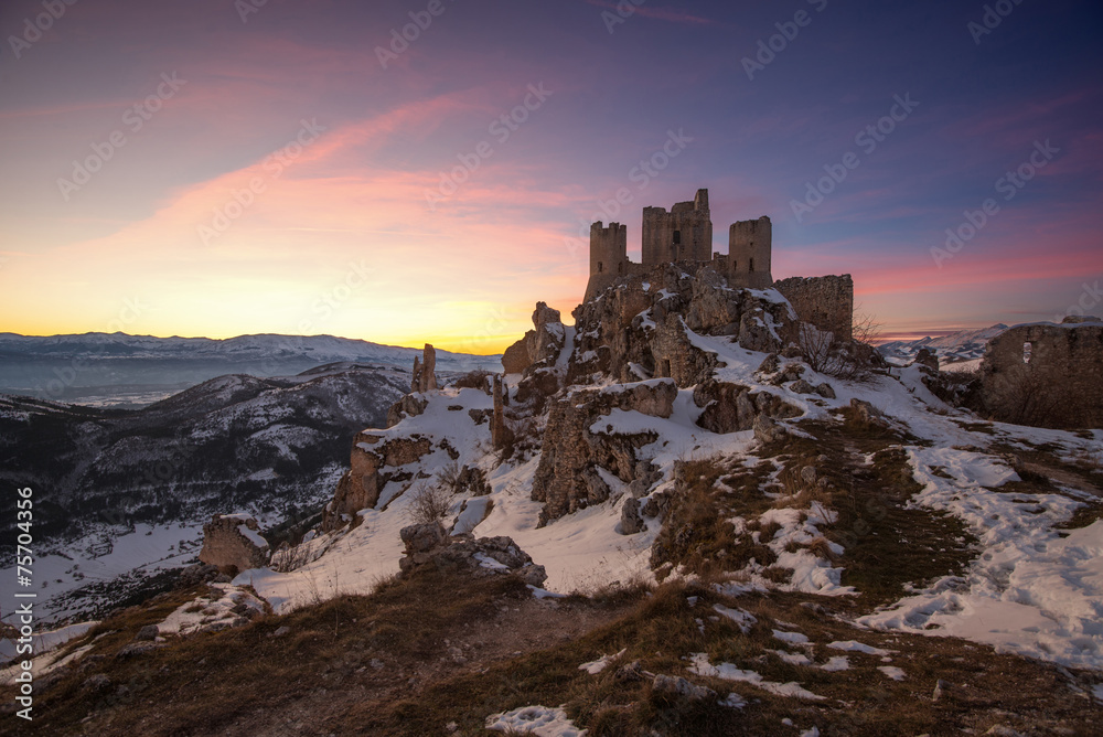 Panoramic view of Rocca Calascio in winter time with dramatic sk