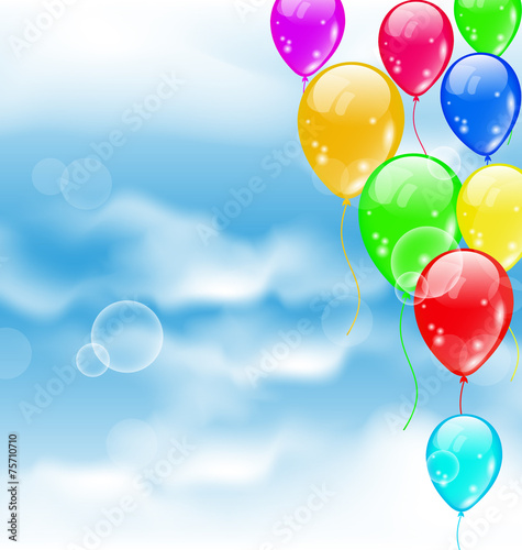Flying colourful balloons in blue sky
