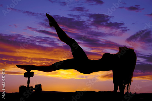Fototapeta Naklejka Na Ścianę i Meble -  silhouette of a fitness woman body up on weights leg up