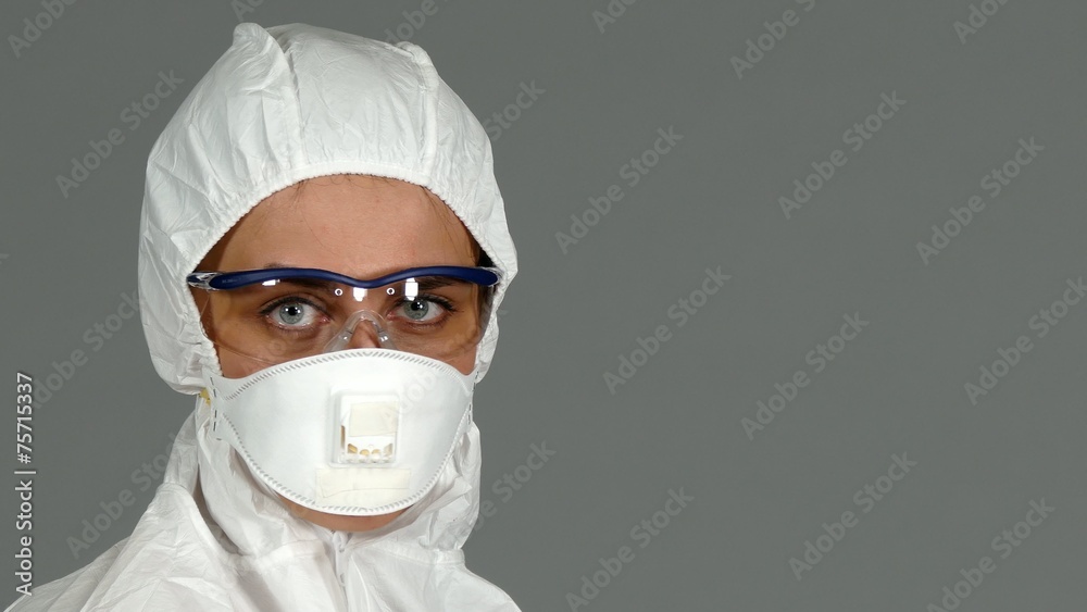 Worker in biological protective suit on grey background Worker in biological protective suit on grey background