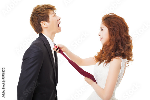 bride pulling on groom tie for control concept