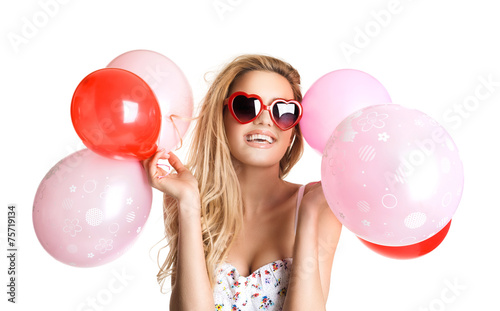 Young beautiful woman with glasses holding red pink balloons, va