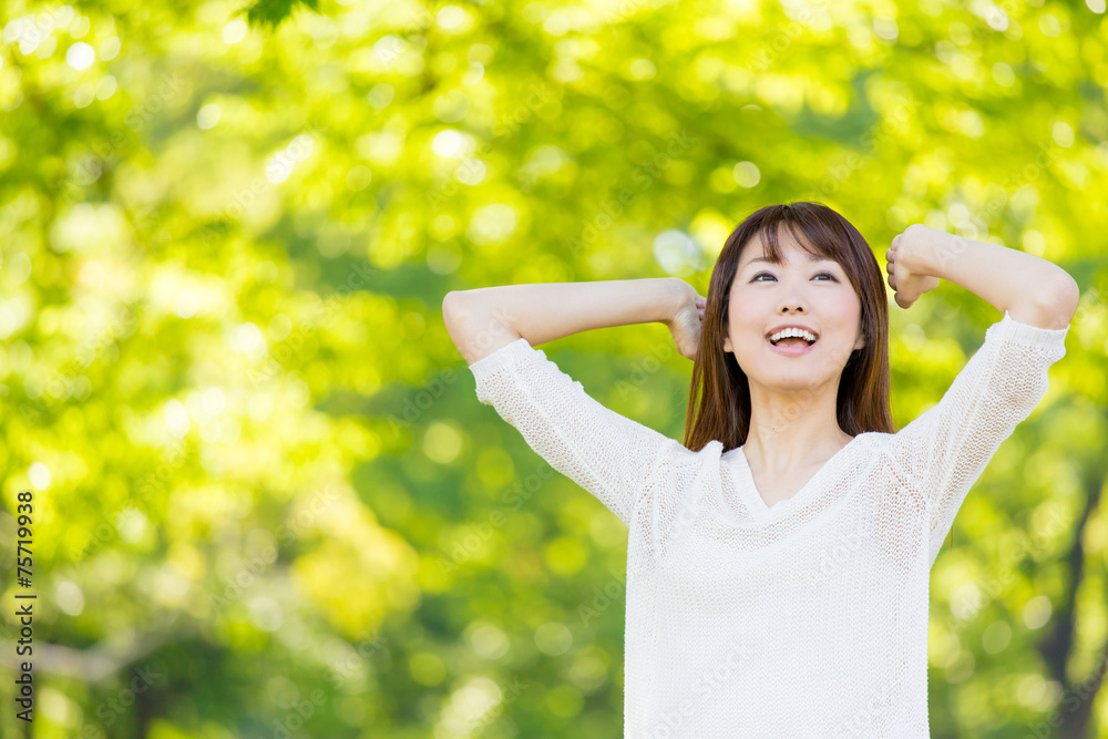 young asian woman relaxing in the park young asian woman relaxing in the park