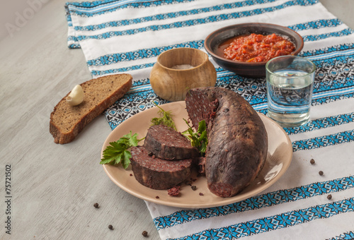Ring pudding sausages on a plate with glass of vodka photo