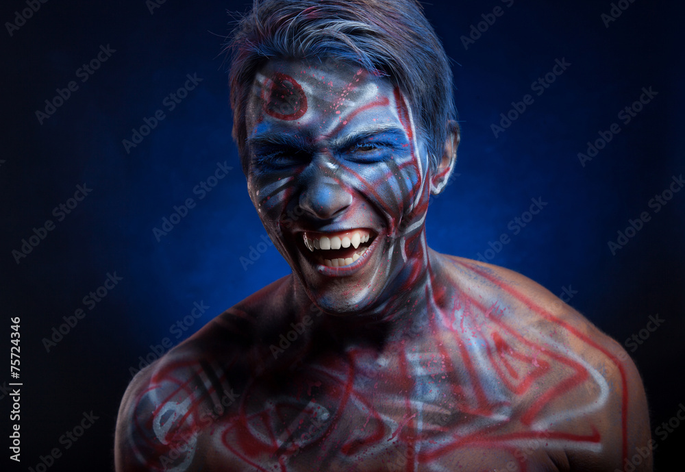 A creepy portrait of a man with bloody body art and face art A creepy portrait of a man with bloody body art and face art