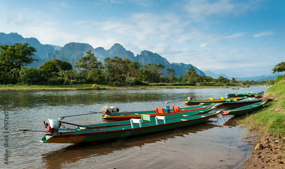 Obraz premium long tail boats on Song river, Vang Vieng,Laos.