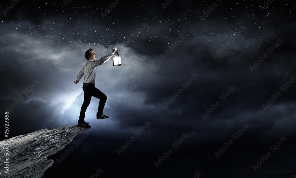 Businessman in search in darkness Businessman in search in darkness