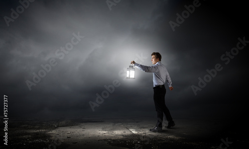 Businessman in search in darkness