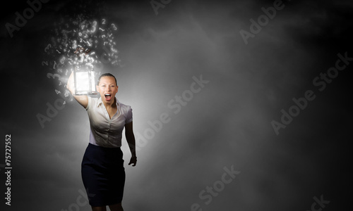 Businesswoman with lantern © Sergey Nivens