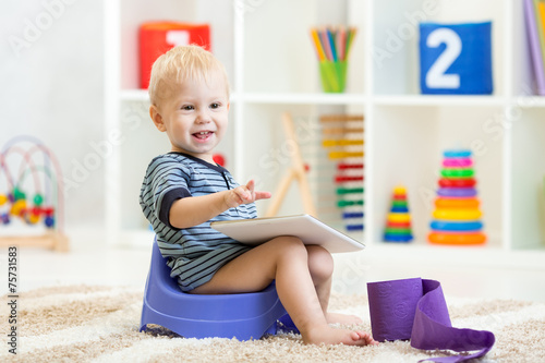 smiling child sitting on ch...