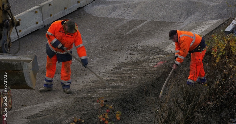 4K, Two construction workers shoveling gravel on highway 4K, Two construction workers shoveling gravel on highway