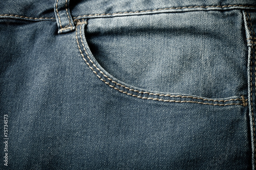 The pocket of jeans. Cloth background. Toned