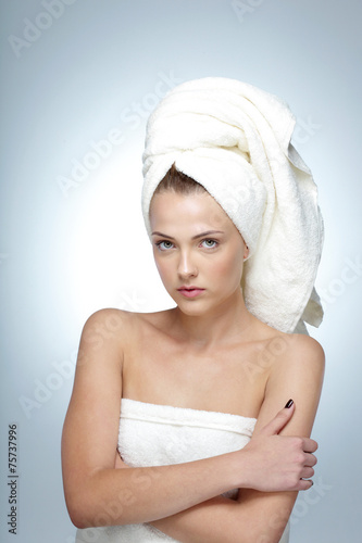 Portrait of cute young woman with fresh skin and towel on head
