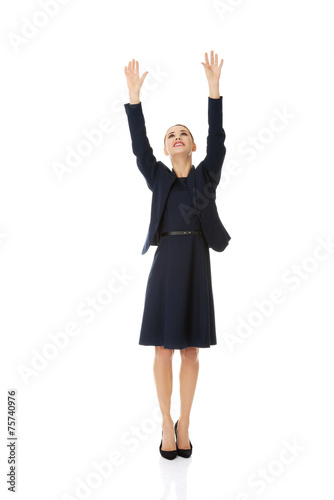 Businesswoman holding hands up