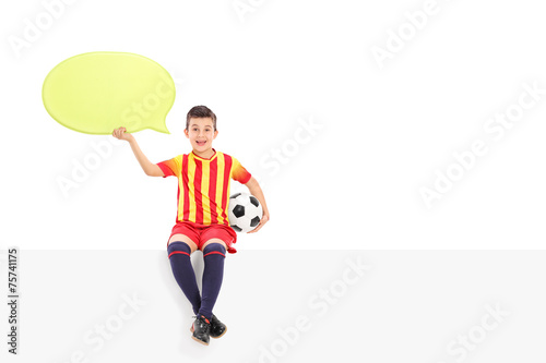 Fototapeta Naklejka Na Ścianę i Meble -  Junior football player holding a speech bubble