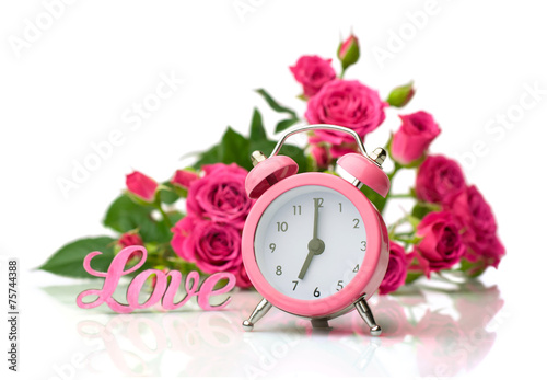 Valentine's Day.Pink roses and alarm clock