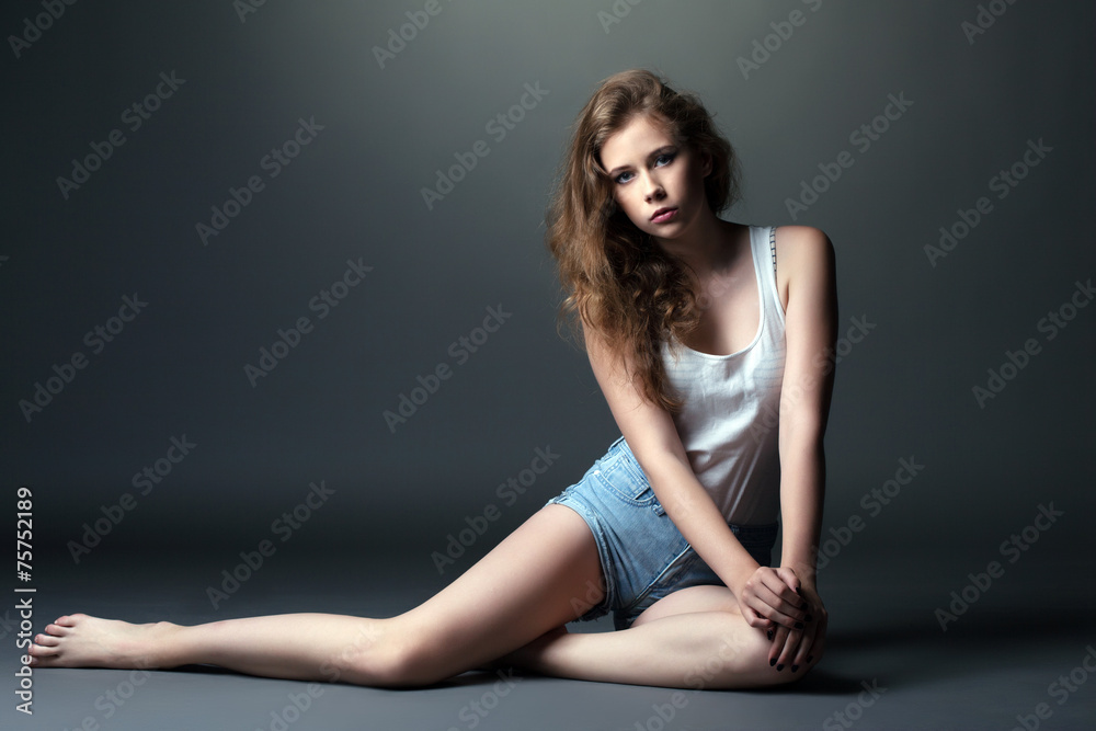 Skinny young model posing in studio, on gray Stock Photo | Adobe Stock