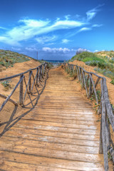 Fototapete Abstieg zum Strand Sandiger Pfad zum einsamen Strand  © Gabriele Maltinti