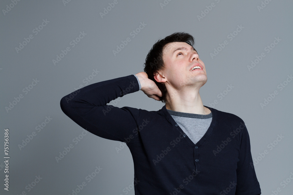 Attractive young man looking up and smiles Attractive young man looking up and smiles