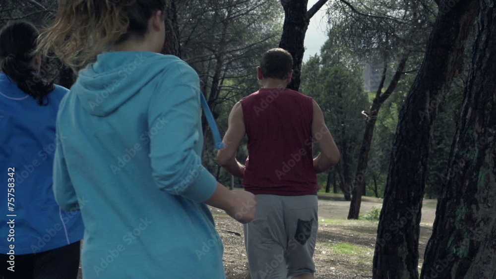 Young people jogging in park, slow motion shot at 240fps Young people jogging in park, slow motion shot at 240fps