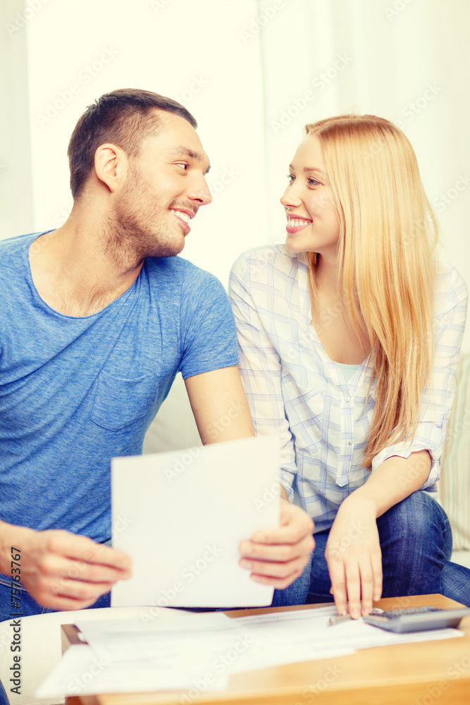 smiling couple with papers and calculator at home smiling couple with papers and calculator at home