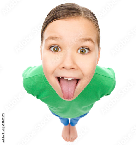 фотографія Funny little girl sticking her tongue out