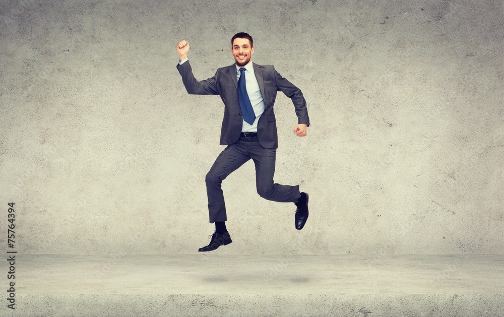 smiling businessman jumping