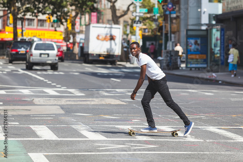 Black Boy Skating with Longboard on the Road