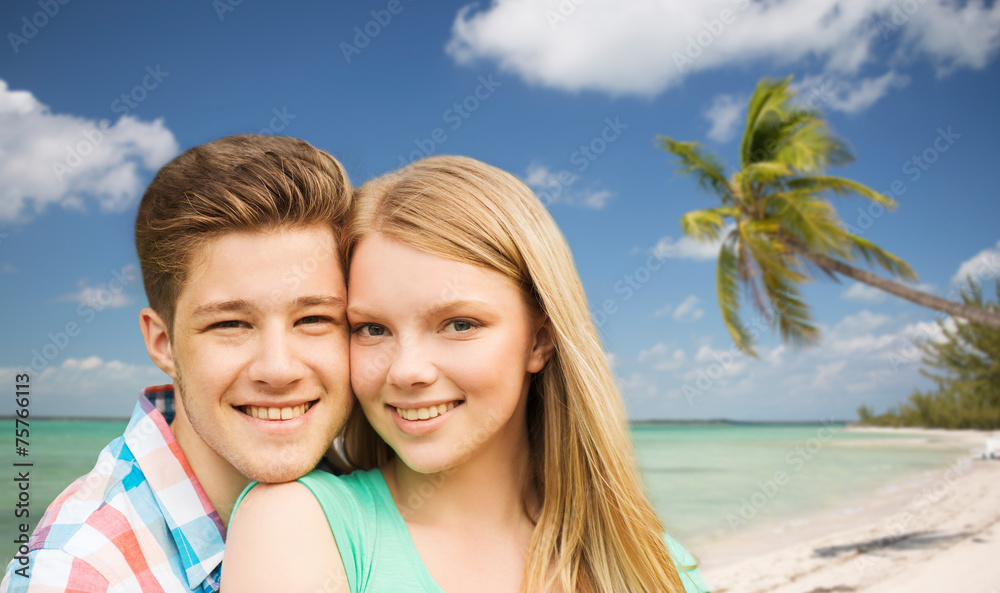 smiling couple hugging over beach background