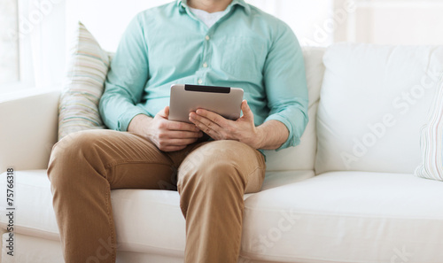 close up of man with tablet pc computer at home