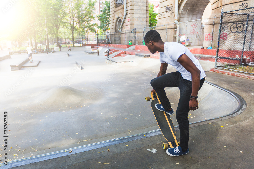 Fototapeta premium Black Boy Skating at Park with Longboard