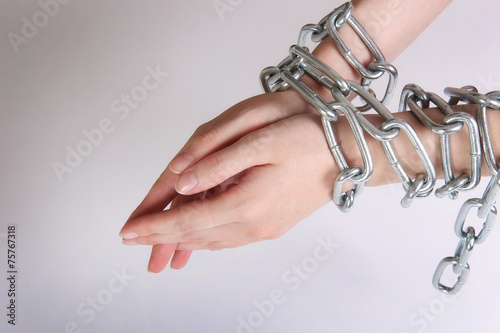 female hands tied by chain