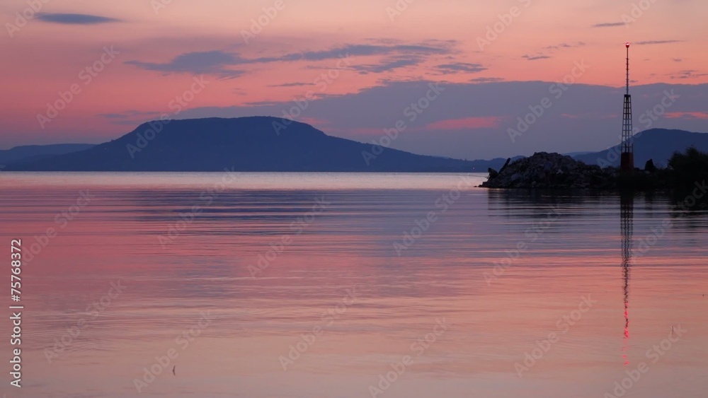 Twilight on Balaton lake with Badacsony and soft water ripples