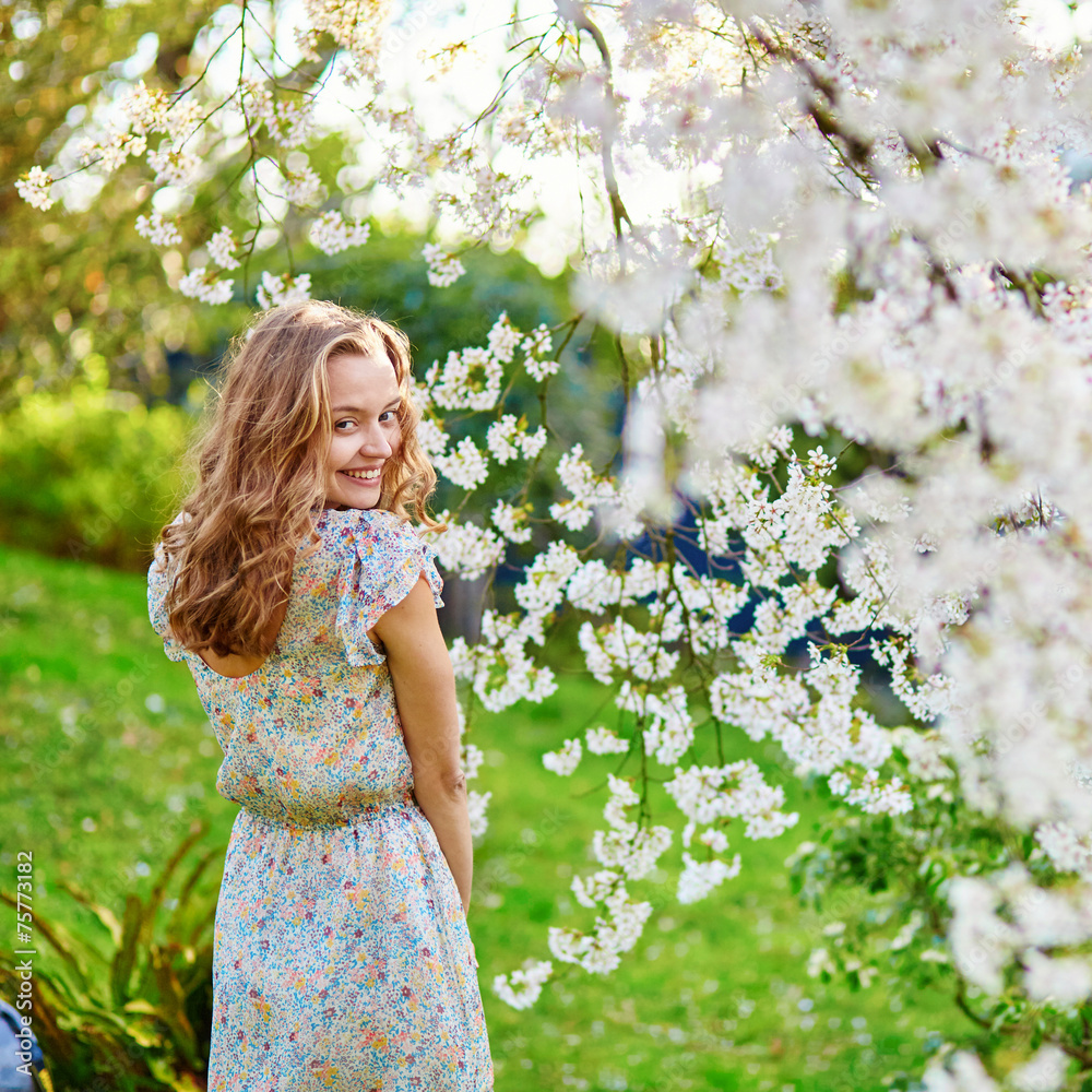 Young woman in cherry blossom garden Young woman in cherry blossom garden