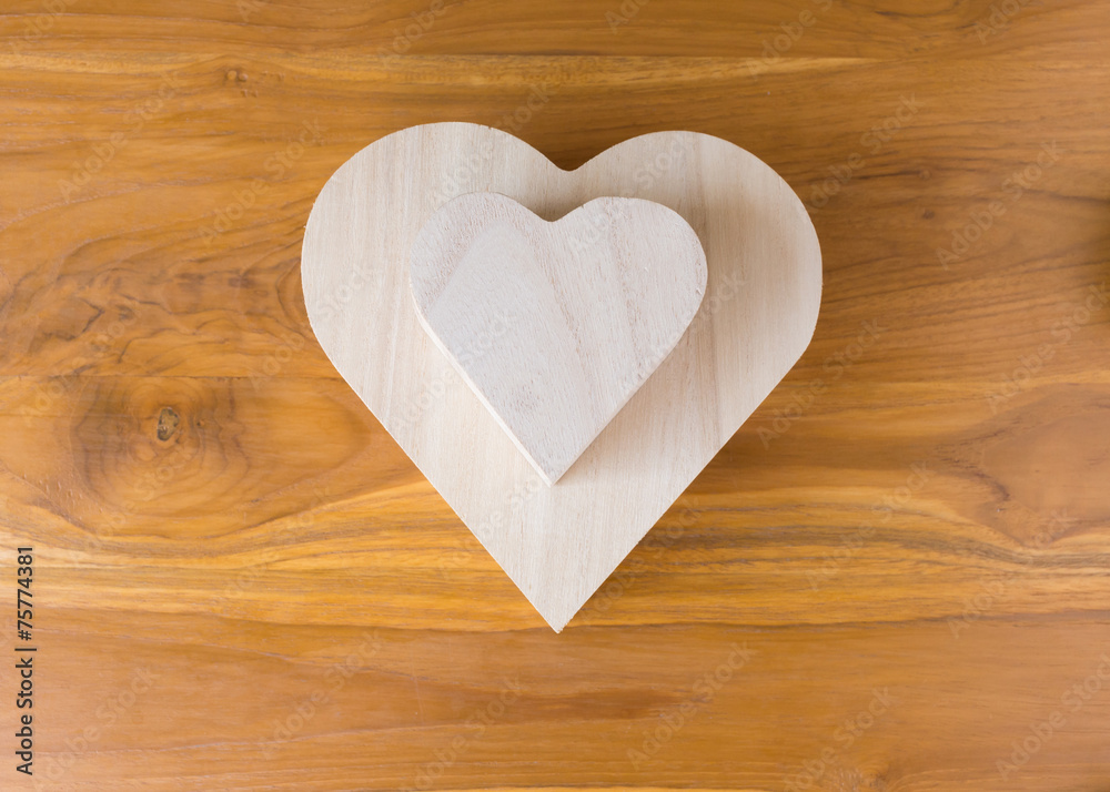wood box shaped heart on brown wooden background