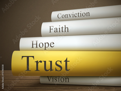 book title of trust isolated on a wooden table