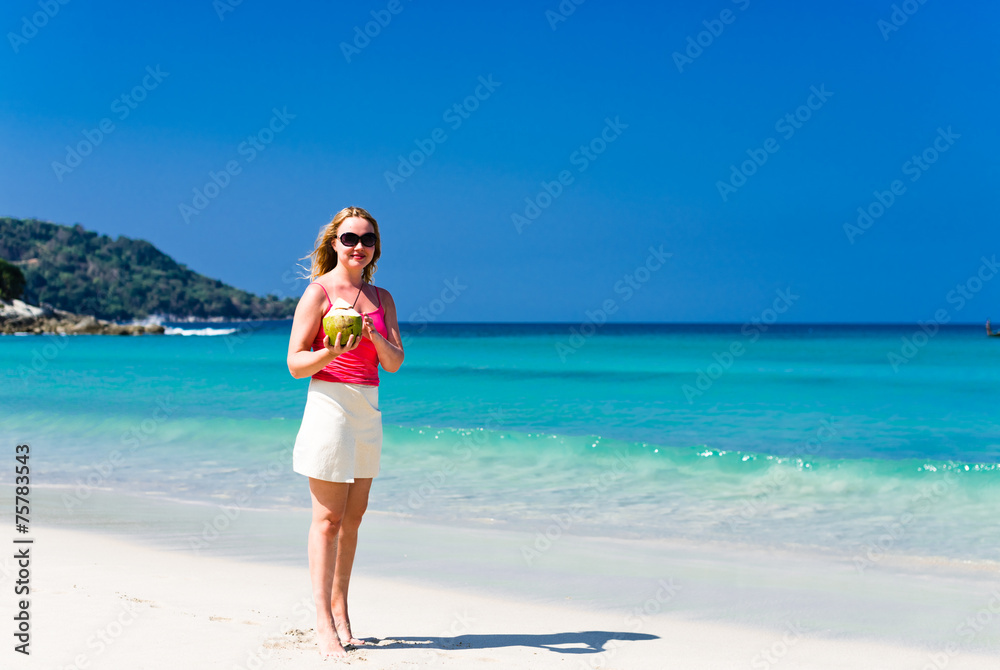 Happy young woman drinking coconut milk on beach Happy young woman drinking coconut milk on beach