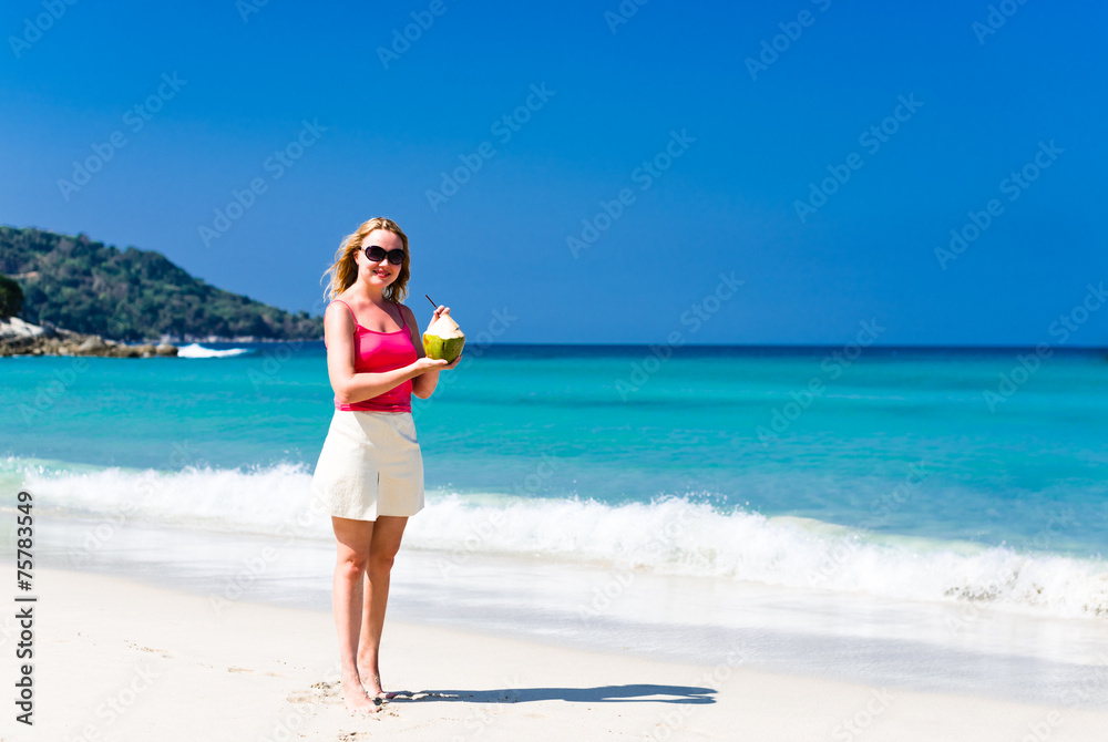 Happy young woman drinking coconut milk on beach Happy young woman drinking coconut milk on beach
