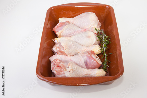 Raw chicken little legs with rosemary