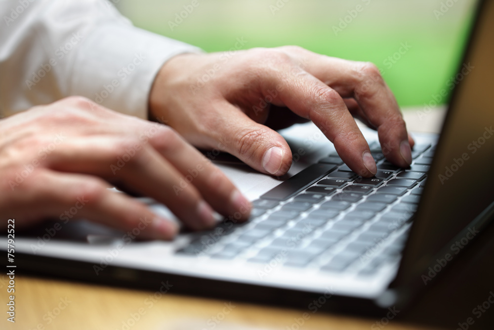 Hands typing on laptop computer Hands typing on laptop computer