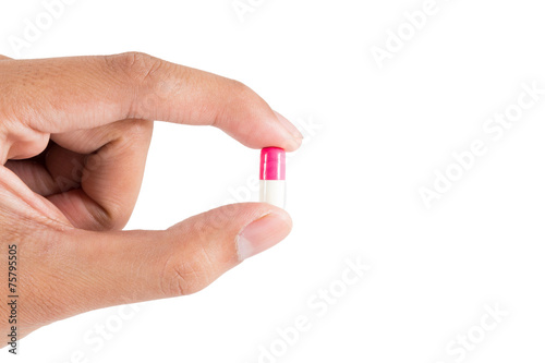 Isolated of Hand holding a pill capsule.