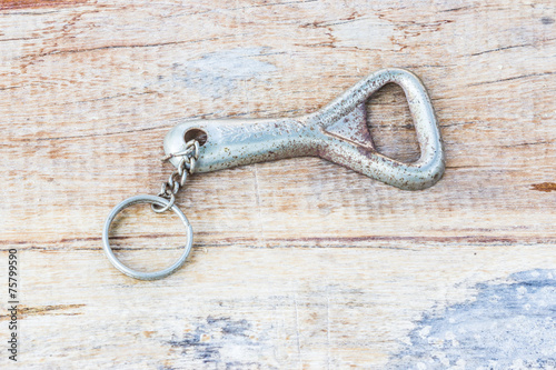 bottle opener and a metal golden cap on the table