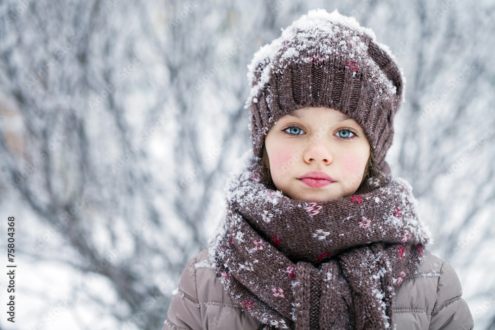 Happy little girl on the background of a winter park Happy little girl on the background of a winter park