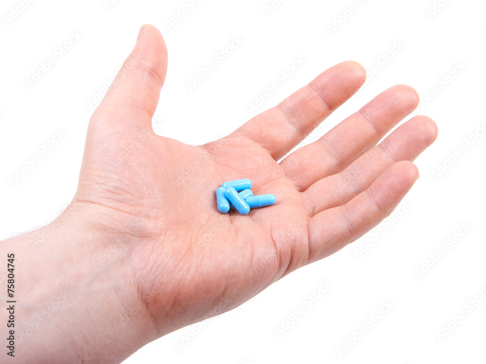 Hand holding pills. Isolated on white background Hand holding pills. Isolated on white background