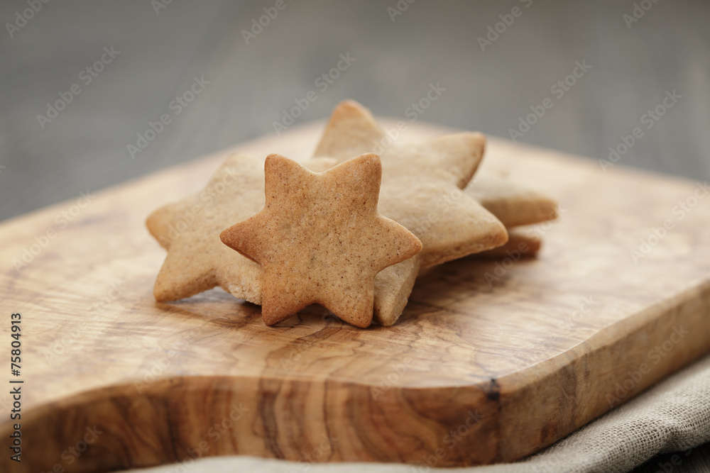 homemade star shape ginger cookies on olive board